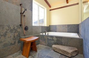 Classic-Japanese-bath-with-simple-teak-stool-and-daft-use-of-stone